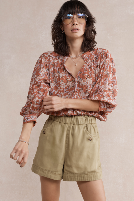 Detail of the warm clay ditsy floral pattern and trim on the blouse