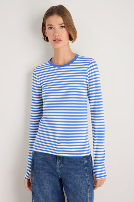 Model wearing a blue and white striped long sleeve jersey top