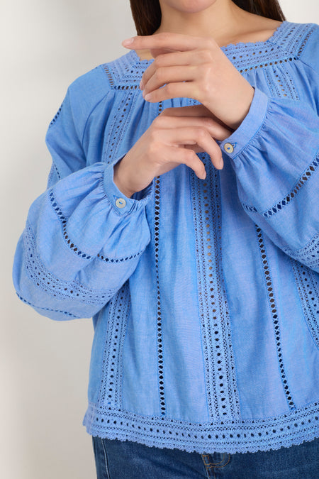 Model wearing a chambray blue square neck top with long sleeves