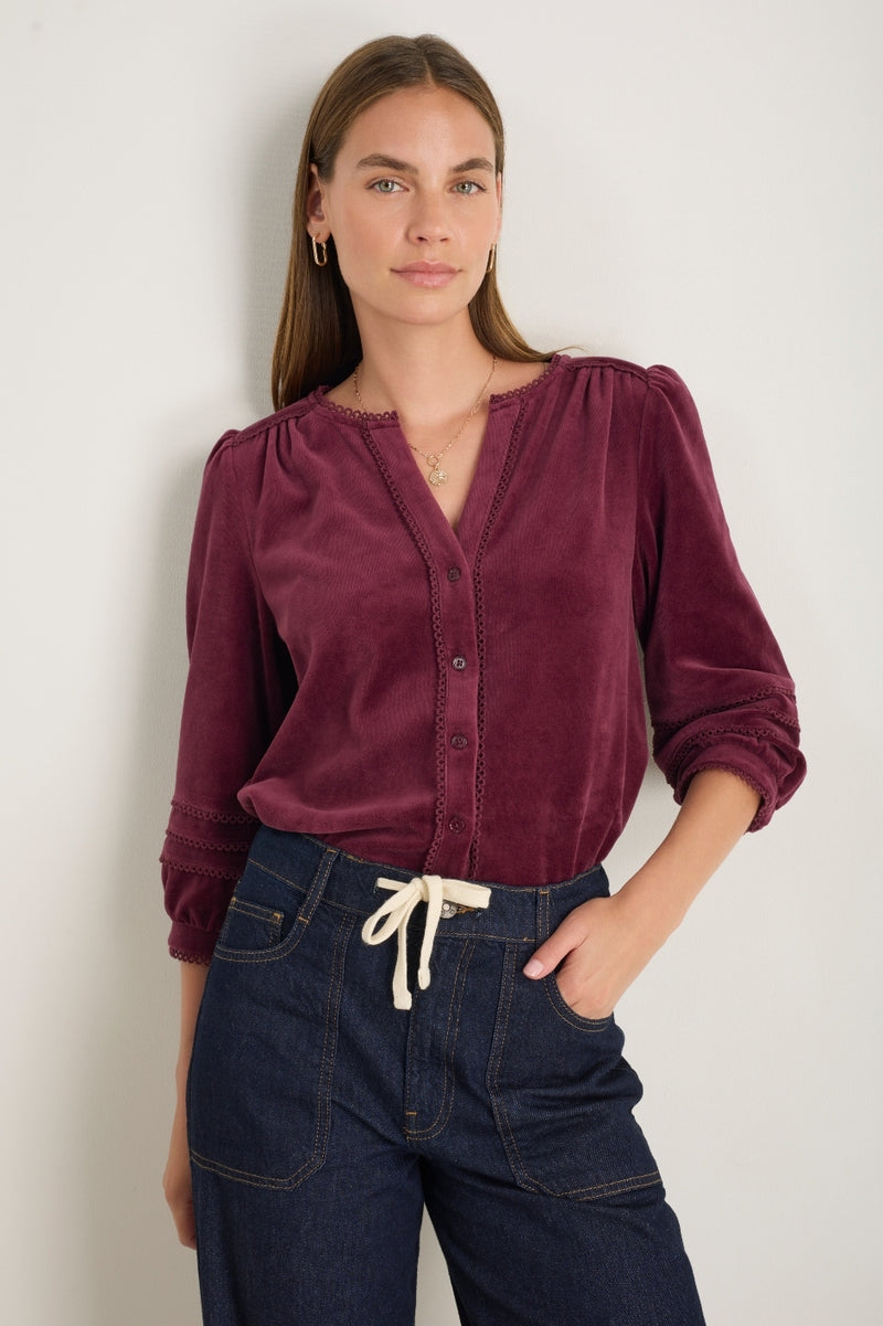 Woman wearing Velma deep fig velour blouse